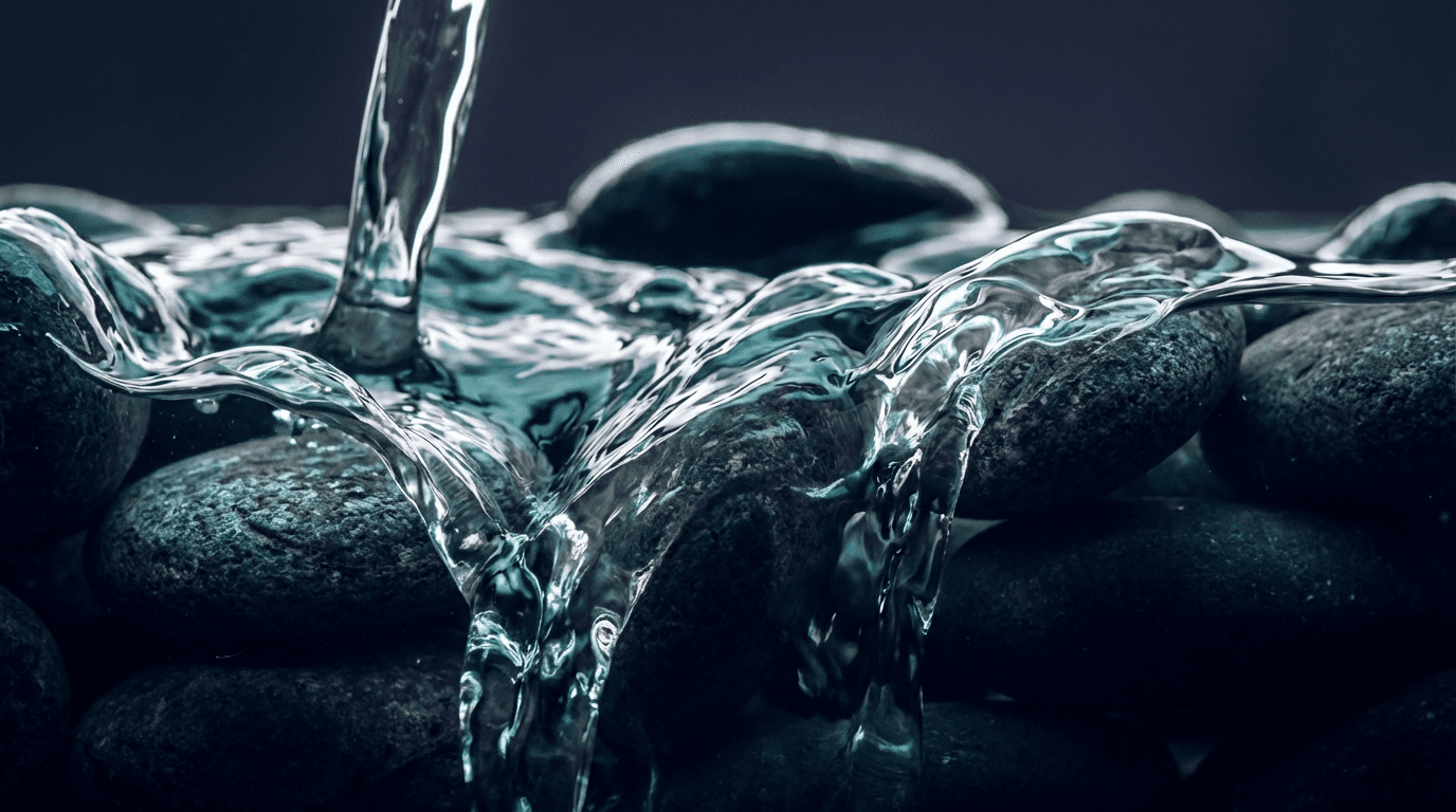 River water flowing rapidly over rocks with energy infrastructure at the edge